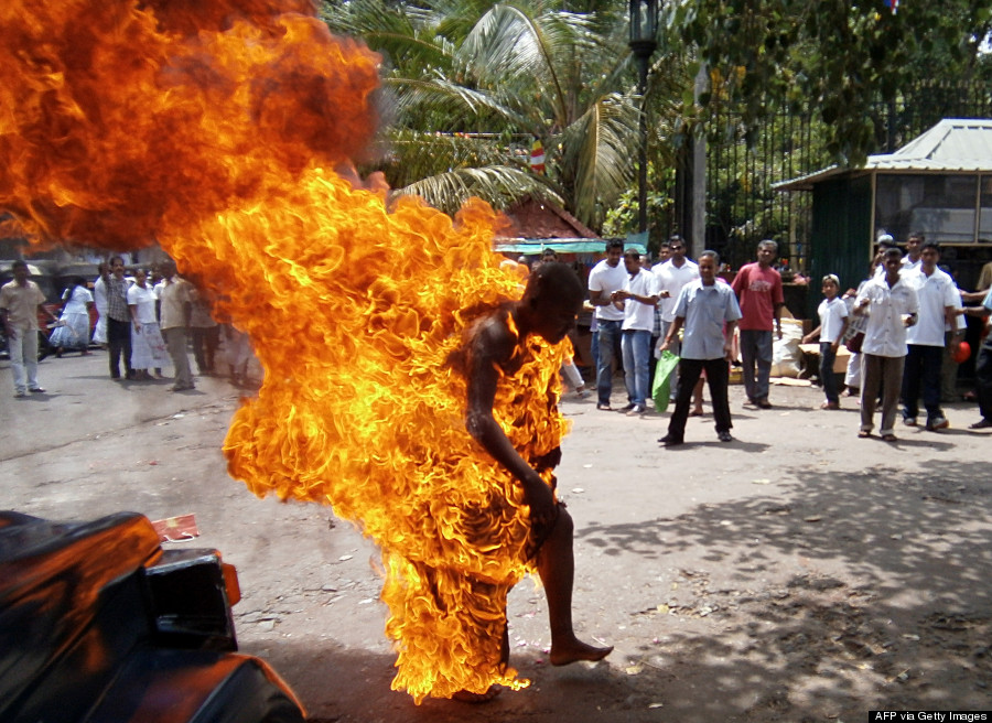 Sri Lankan Buddhist monk Bowatte Indaratane is engulfed in flames after he set himself on fire in the central town of Kandy on May 24, 2013. Indaratane self-immolated in the central town of Kandy to protest against the slaughter of cattle in the country, reports said. AFP PHOTO/J.A.L JAYASINGHE (Photo credit should read J.A.L Jayasinghe/AFP/Getty Images)