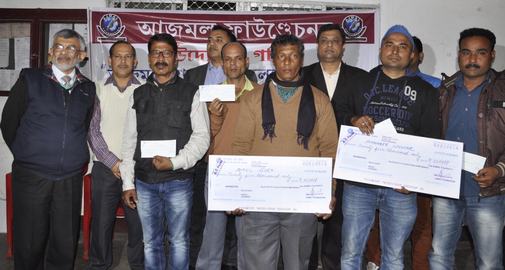 Officials of Ajmal Foundation giving away financial aid to ailing journalist during a function held at Guwahati Press Club on Wednesday. Altogether 5 journalist of print and electronic media being distributes cheques.