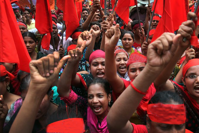 Protestors shout slogans calling for better working conditions for garment workers during a May Day rally on Wednesday, May 1, 2013, in Dhaka, Bangladesh. Thousands of workers paraded through central Dhaka on May Day to demand safer working conditions and the death penalty for the owner of a building housing garment factories that collapsed last week in the country's worst industrial disaster, killing at least 402 people and injuring 2,500. (AP Photo/Wong Maye-E)